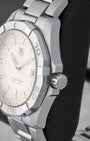 Right side profile view highlighting the screw-down crown and engraved steel unidirectional rotating bezel on a TAG Heuer Aquaracer WAY1111