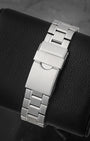 A rear view of the flat three-row sports link metal band focusing on the secure fold-over safety latch deployant buckle stamped with the historical TAG Heuer block text