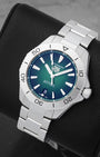 An angled studio profile shot of the 40mm stainless steel TAG Heuer Aquaracer Professional 200 automatic watch on a leather cushion