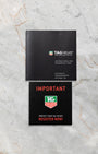 Official TAG Heuer instruction booklet and important service documentation laid out flat on a grey marble surface