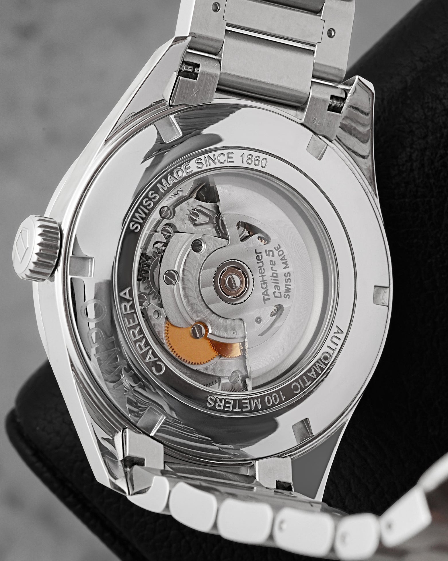 The reverse chassis profile through a sapphire exhibition window revealing the Swiss automatic Calibre 5 movement decorated with Geneva stripes and a gold-engraved rotor weight
