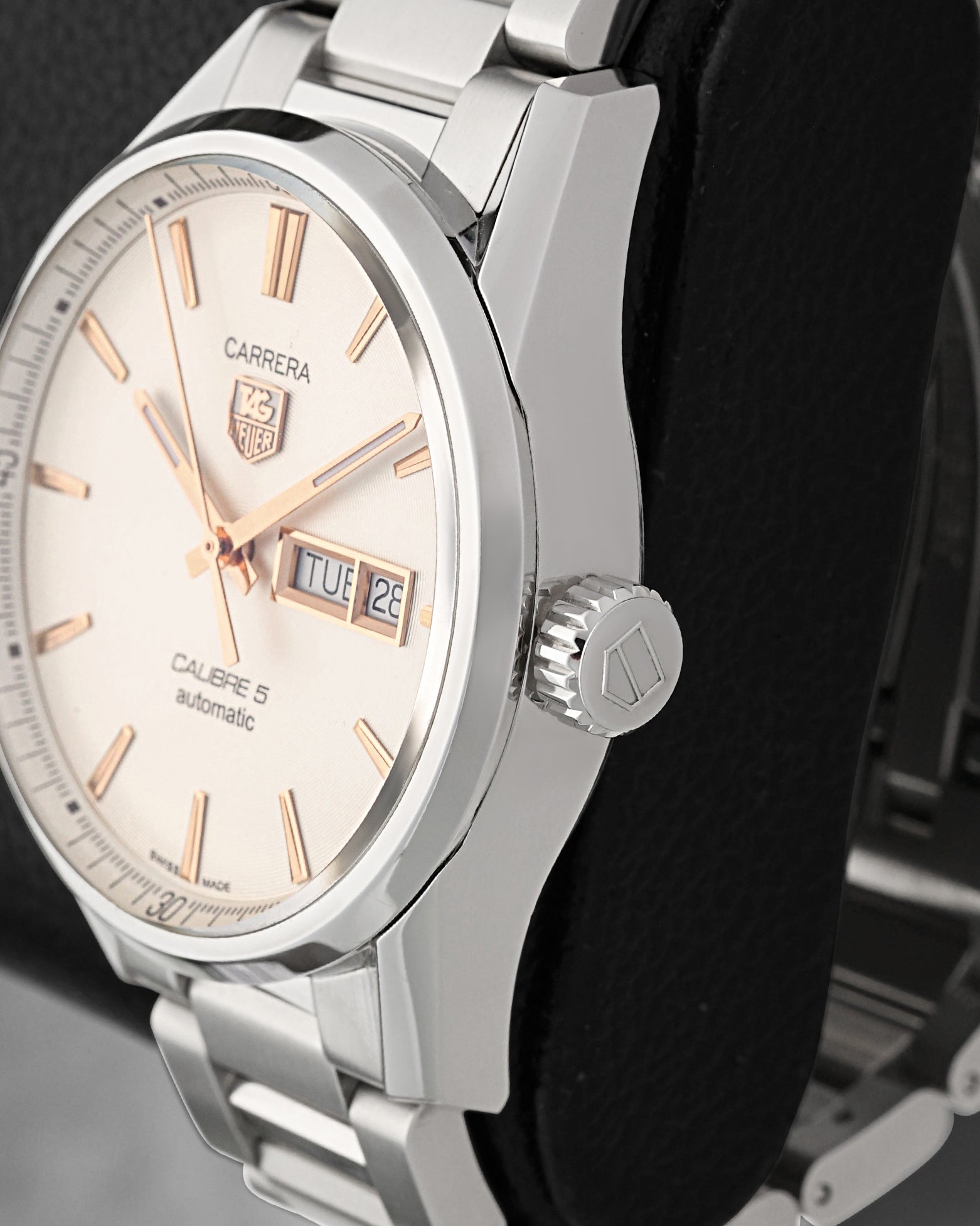 Close-up right profile view of the watch head focusing on the crisp, high-polished bezel edge and the clean fluted push-pull winding crown signed with the TAG Heuer shield logo