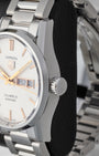 Side profile view of the stainless steel case and signed fluted crown of a TAG Heuer Carrera Calibre 5 watch