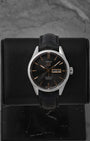 A TAG Heuer Carrera Calibre 5 Day-Date reference WAR201C featuring a black azurage dial with rose gold-plated accents on a black alligator leather strap at Noah's Fine Watches & Jewelry in Dallas