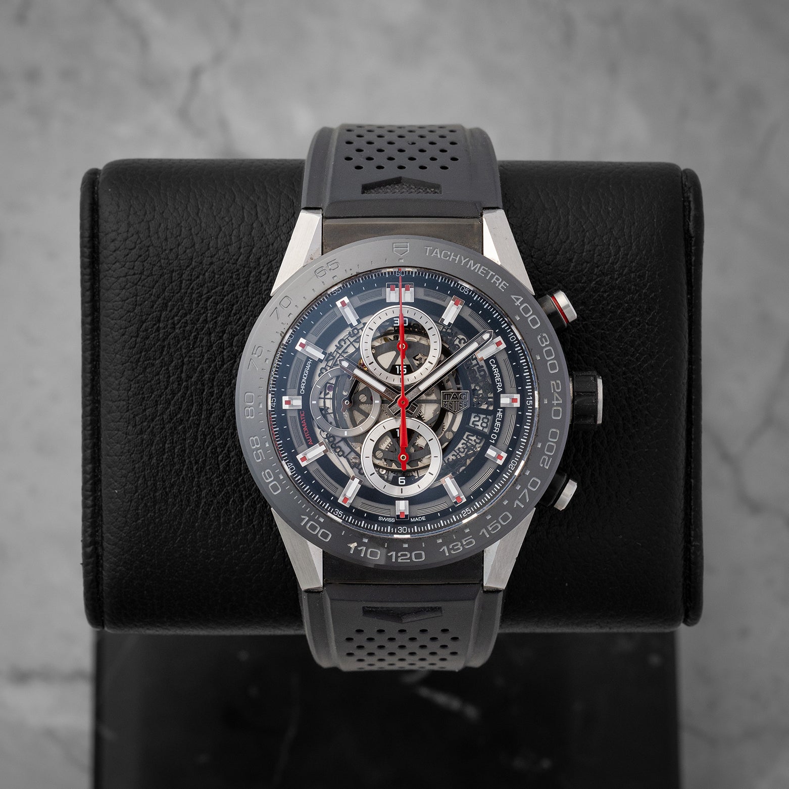 direct studio front portrait of the 45mm TAG Heuer Carrera Calibre Heuer 01 skeleton watch on its black leather display holder