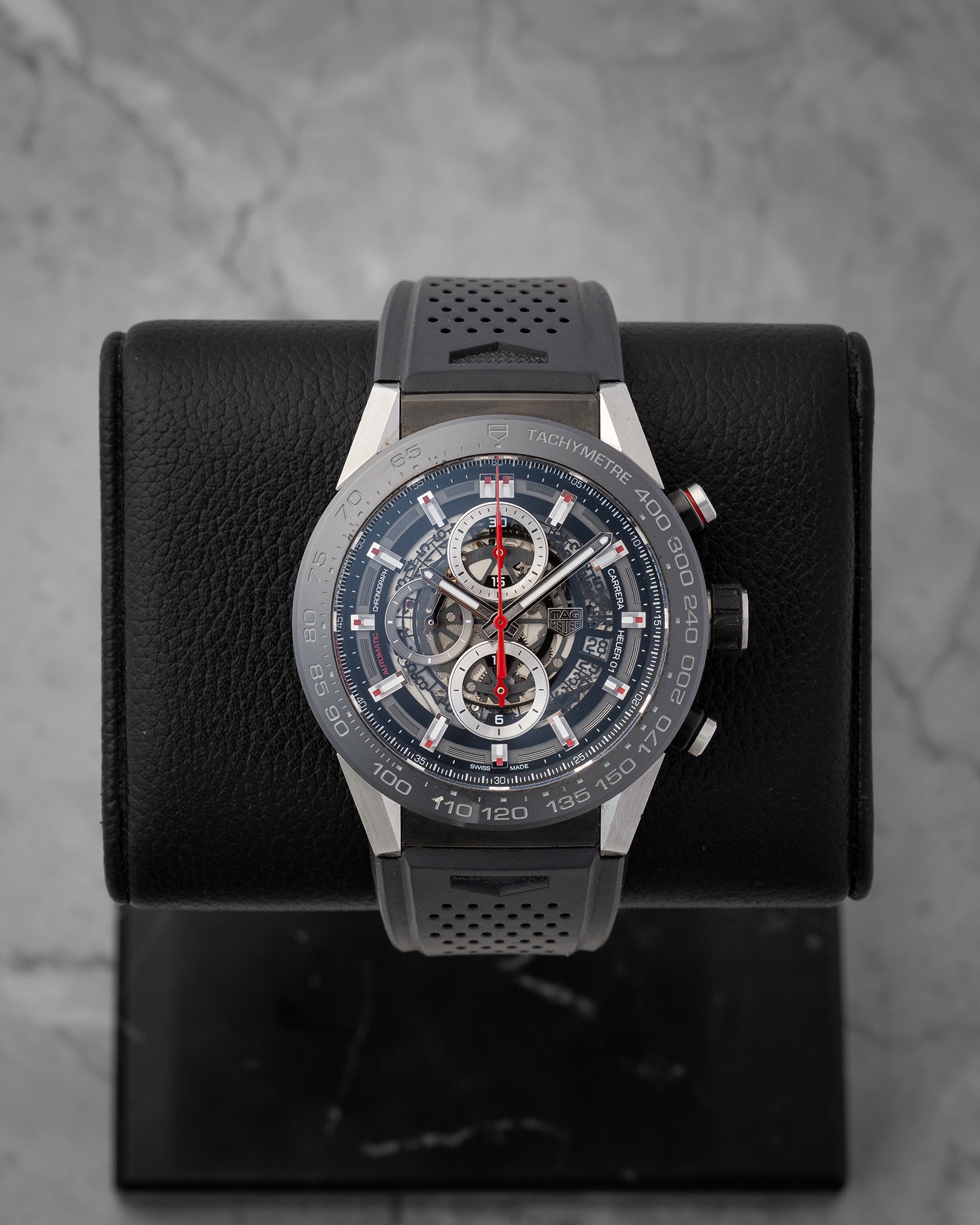 direct studio front portrait of the 45mm TAG Heuer Carrera Calibre Heuer 01 skeleton watch on its black leather display holder