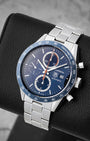 Angled view of TAG Heuer Carrera CV2015 displaying blue chronograph dial, orange sub-dial hands, and blue tachymeter bezel