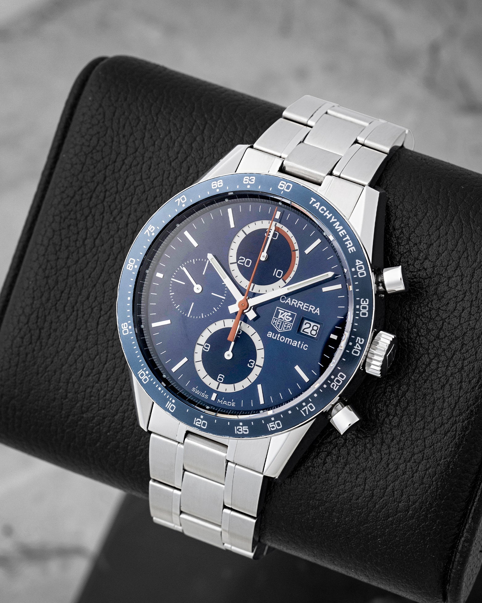 Angled view of TAG Heuer Carrera CV2015 displaying blue chronograph dial, orange sub-dial hands, and blue tachymeter bezel