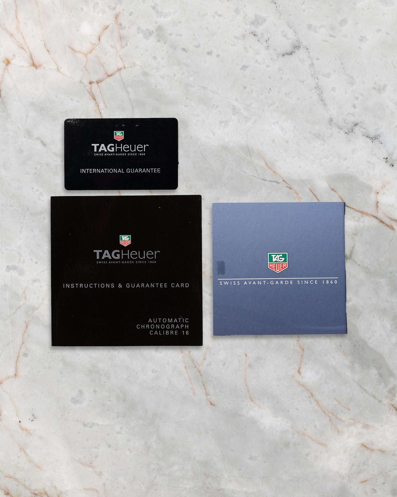 Official TAG Heuer international guarantee card, cardholder, and instruction manuals for Carrera CV2015