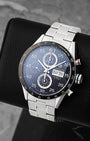 Angled front view of pre owned TAG Heuer Carrera CV2A10.BA0796 featuring a black dial, Arabic numerals, day-date display, and tachymeter bezel