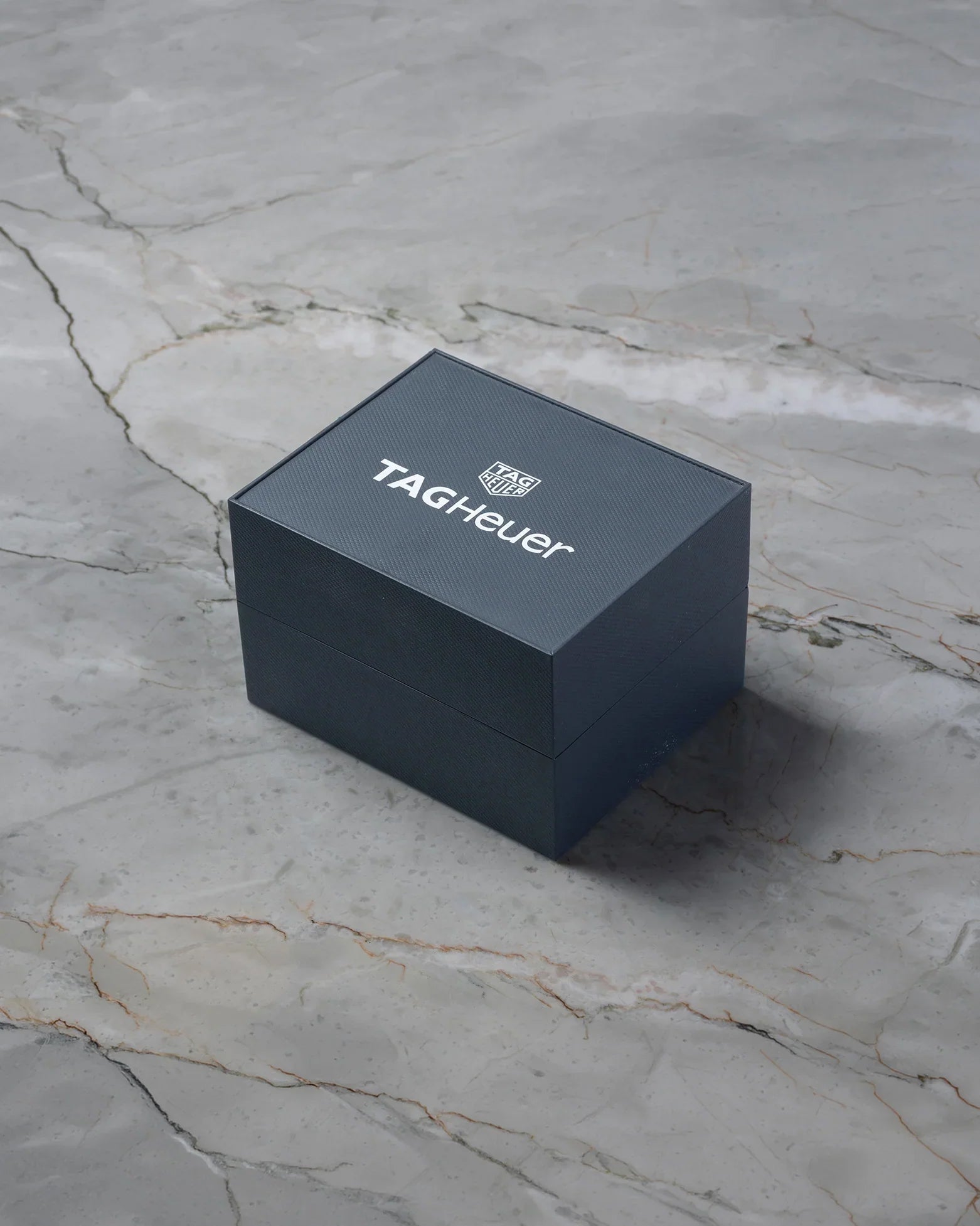 Official black TAG Heuer presentation watch box included with pre-owned Carrera Calibre 16 CV2A10.BA0796 at Noah's Fine Watches & Jewelry in Dallas