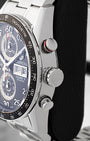 Side profile view showing the stainless steel case, red-ringed chronograph pusher, and fluted winding crown on TAG Heuer Carrera CV2A10.BA0796