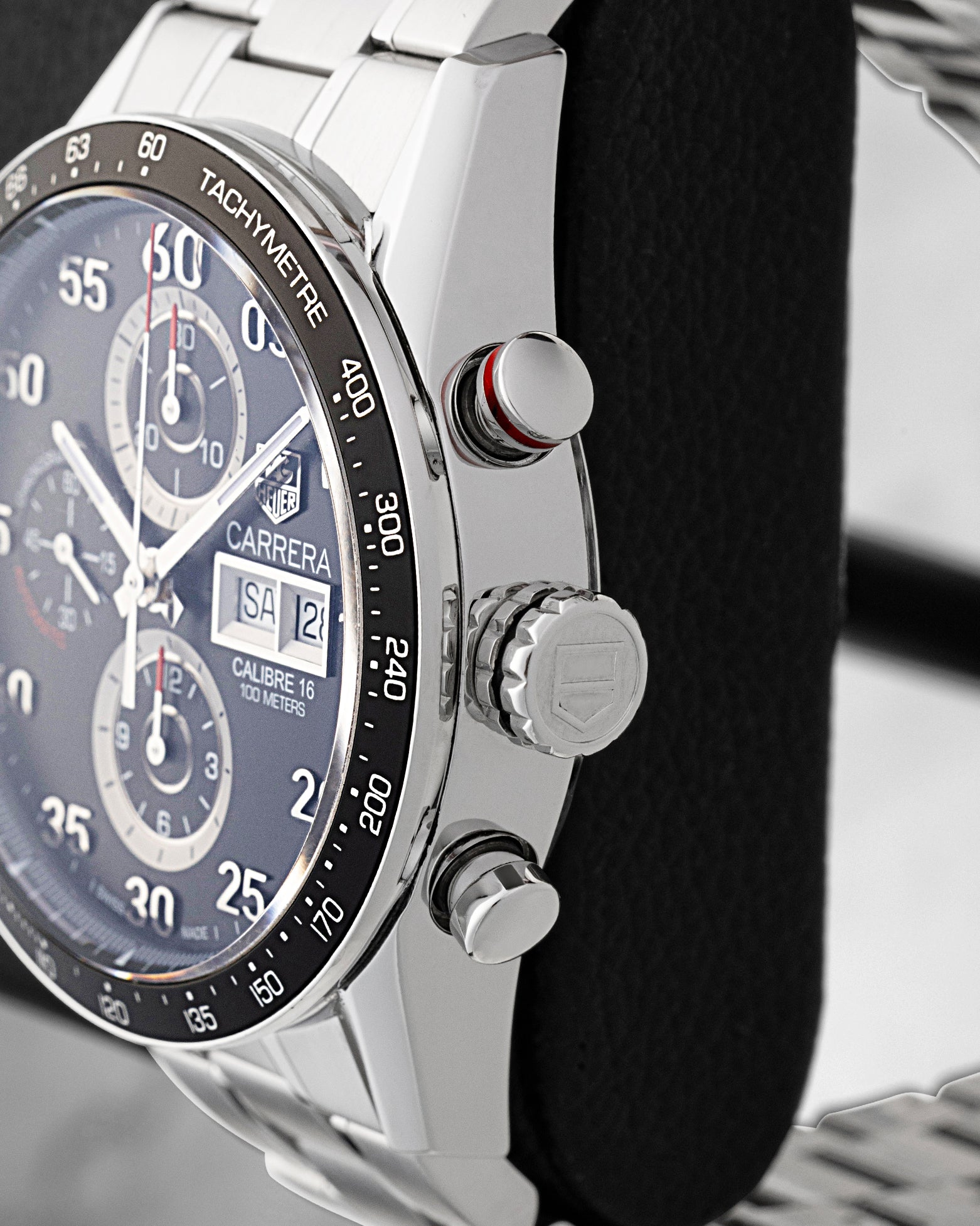 Side profile view showing the stainless steel case, red-ringed chronograph pusher, and fluted winding crown on TAG Heuer Carrera CV2A10.BA0796
