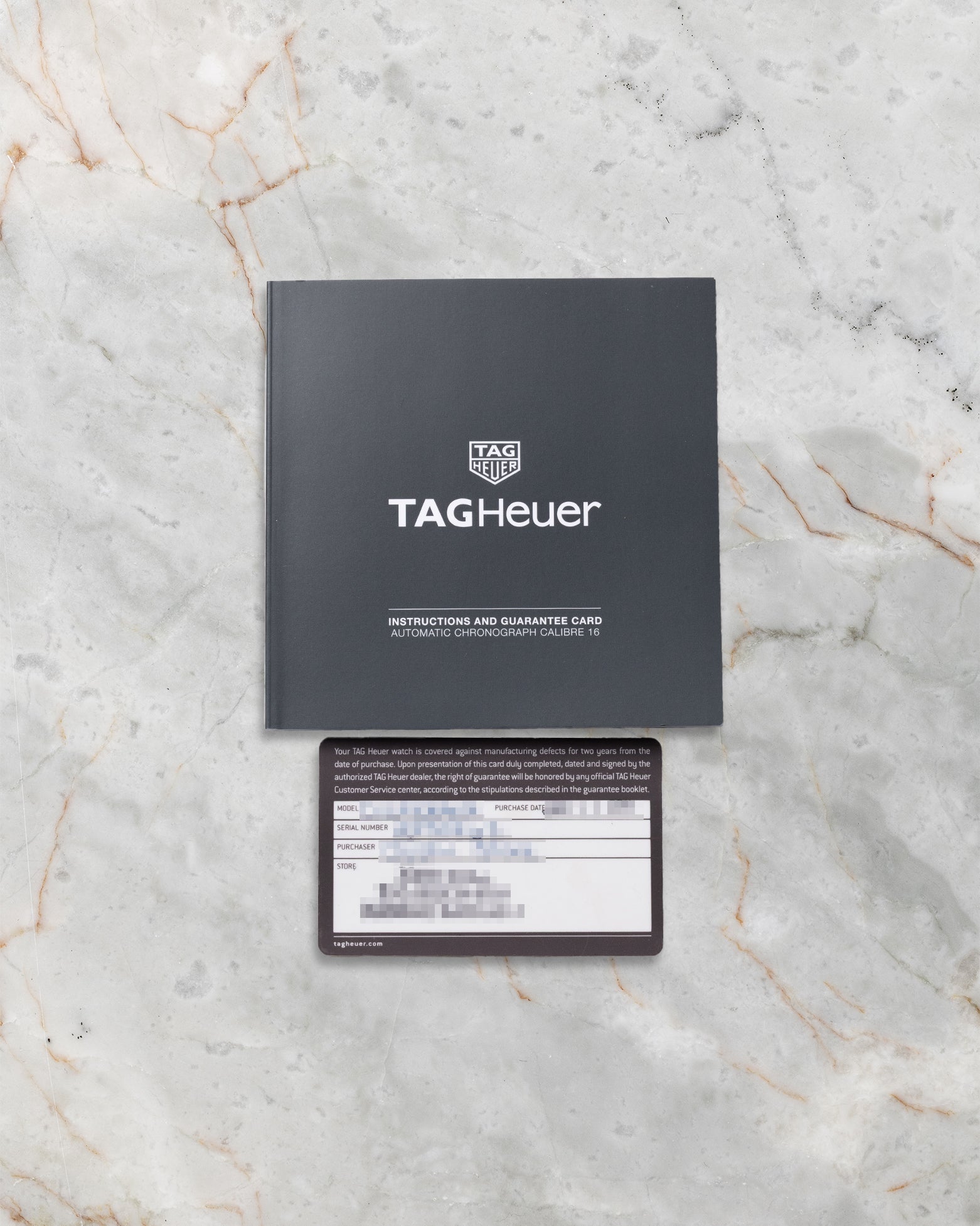 Original TAG Heuer international warranty card and instruction manual booklet included with pre-owned Carrera CV2A10.BA0796