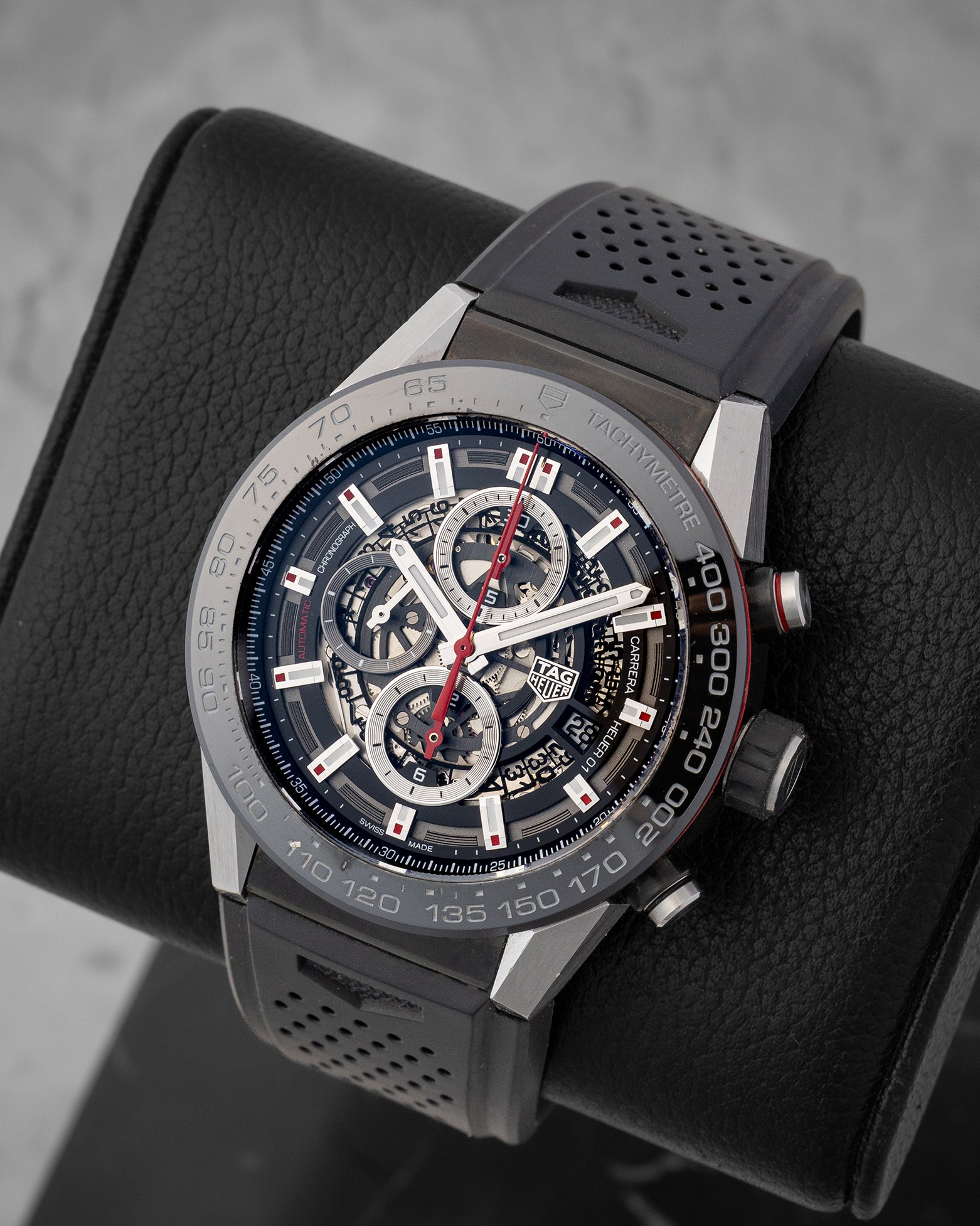 angled top-down studio overview of the skeletonized TAG Heuer Carrera watch highlighting its open-work dial and black ceramic bezel