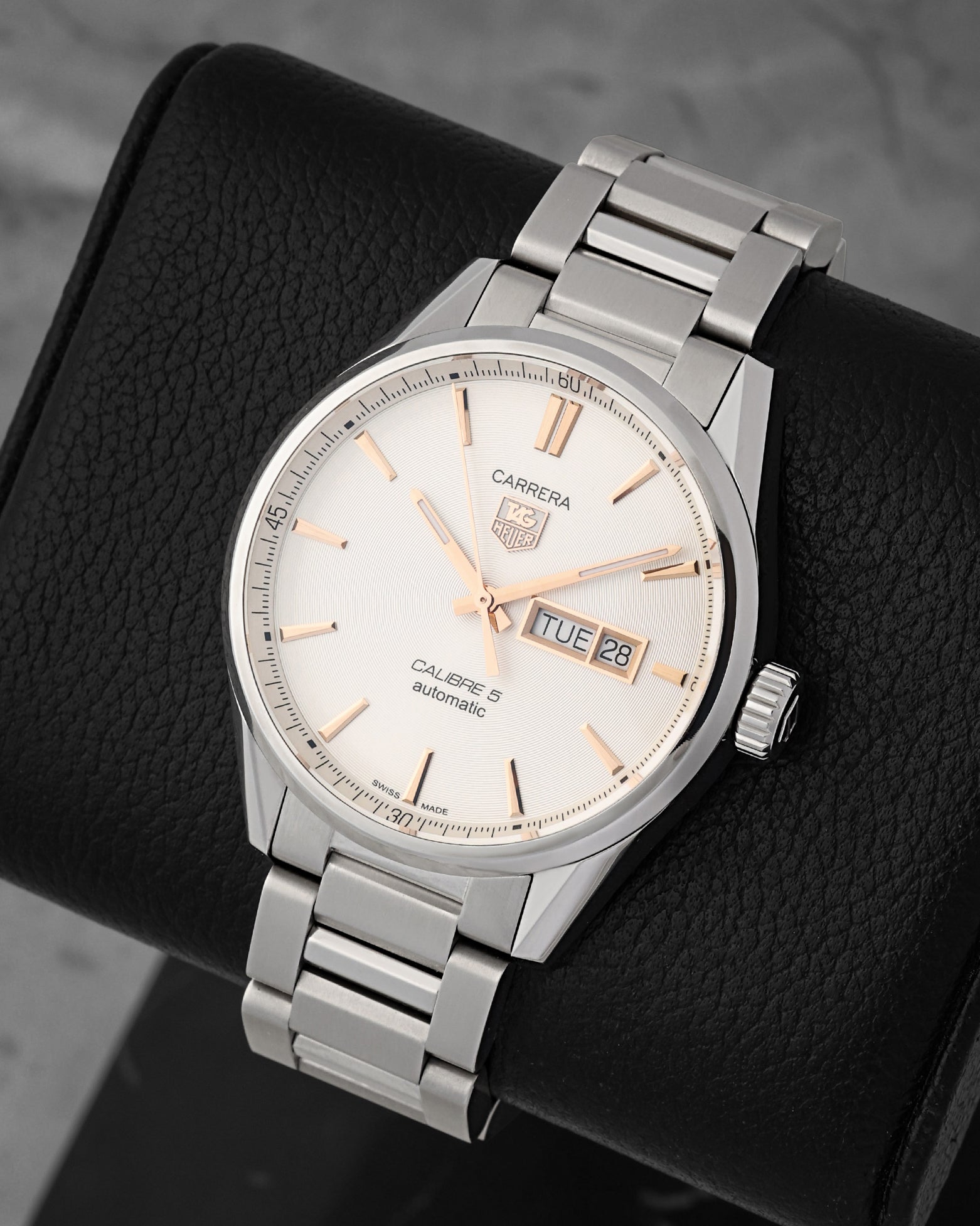 portrait of the 41mm stainless steel Carrera case resting on a black leather cushion to highlight its polished fixed steel bezel ring