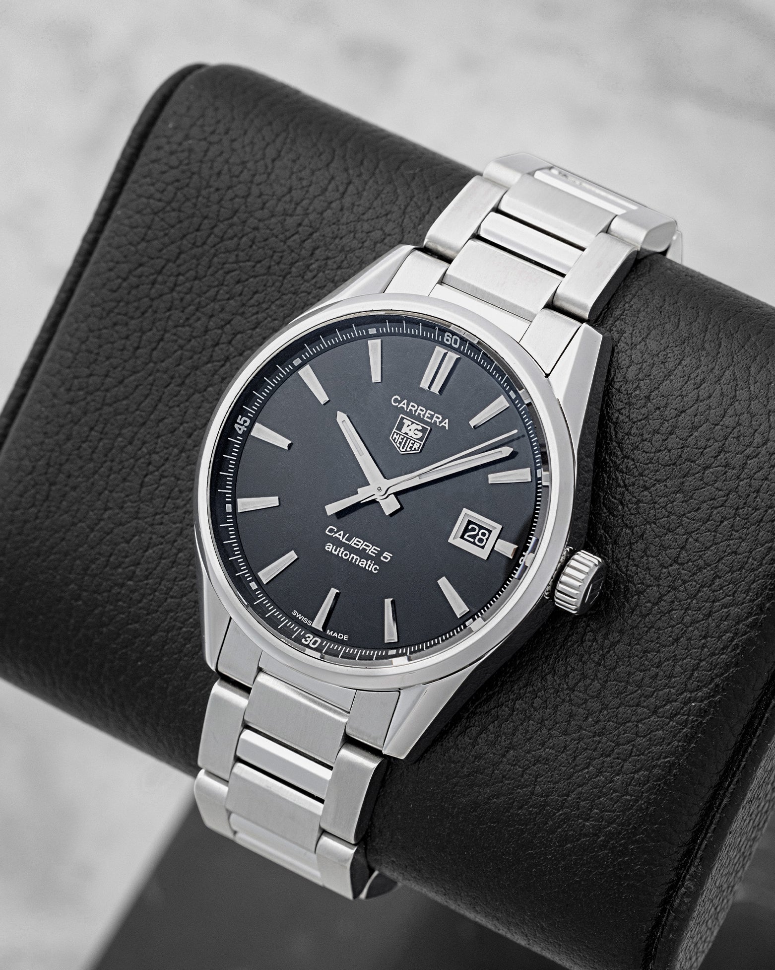 Angled view of 39mm TAG Heuer Carrera WAR211A.BA0782 showing black dial, date display, and stainless steel bezel