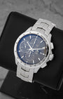 A high-angle three-quarter portrait of the 43mm stainless steel sport chronograph case showcasing its polished steel fixed bezel engraved with a tachymetric scale