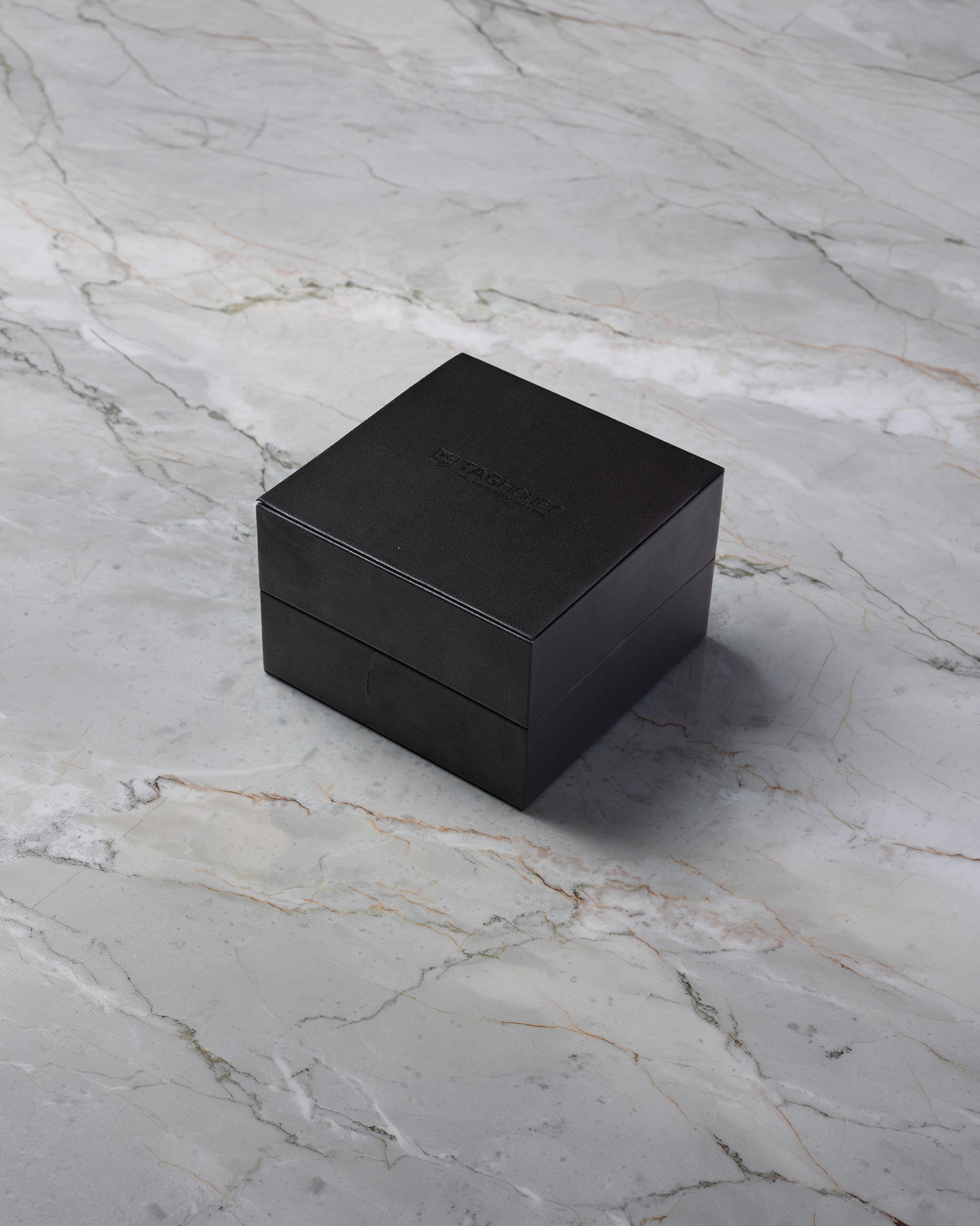 Dark luxury watch presentation box for a TAG Heuer Aquaracer chronograph on display