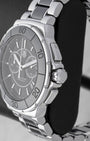 Macro case profile showing the fluted black ceramic bezel side profile, the robust screw-down crown system, and heavy-duty steel chronograph pushers