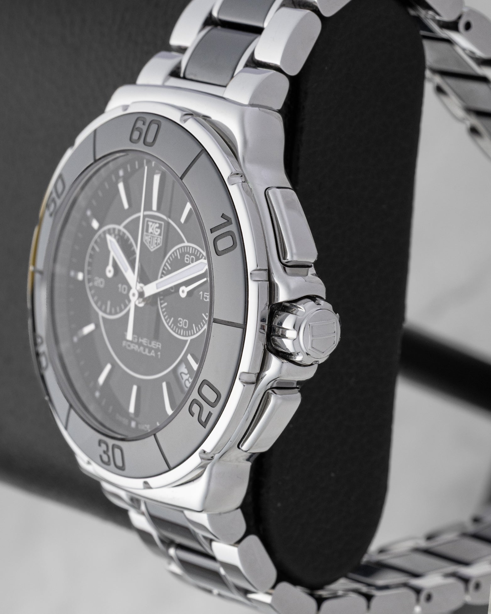 Macro case profile showing the fluted black ceramic bezel side profile, the robust screw-down crown system, and heavy-duty steel chronograph pushers