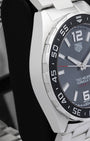 Side profile view of the polished and brushed stainless steel case on the non-crown side of a TAG Heuer Formula 1 Calibre 5 watch