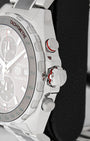 Close-up side view of screw-down crown, red-trimmed chronograph pusher, and black tachymeter bezel on TAG Heuer F1