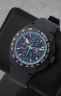 An angled studio profile shot of the black DLC titanium case and rubber strap of a TAG Heuer Formula 1 automatic watch