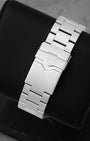 Rear studio view of the brushed three-link stainless steel watch bracelet and folding double-security clasp with the engraved TAG Heuer shield