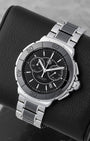 Angled collector view of a 41mm TAG Heuer Formula 1 luxury sports watch highlighting the striking contrast of polished stainless steel and deep black ceramic links