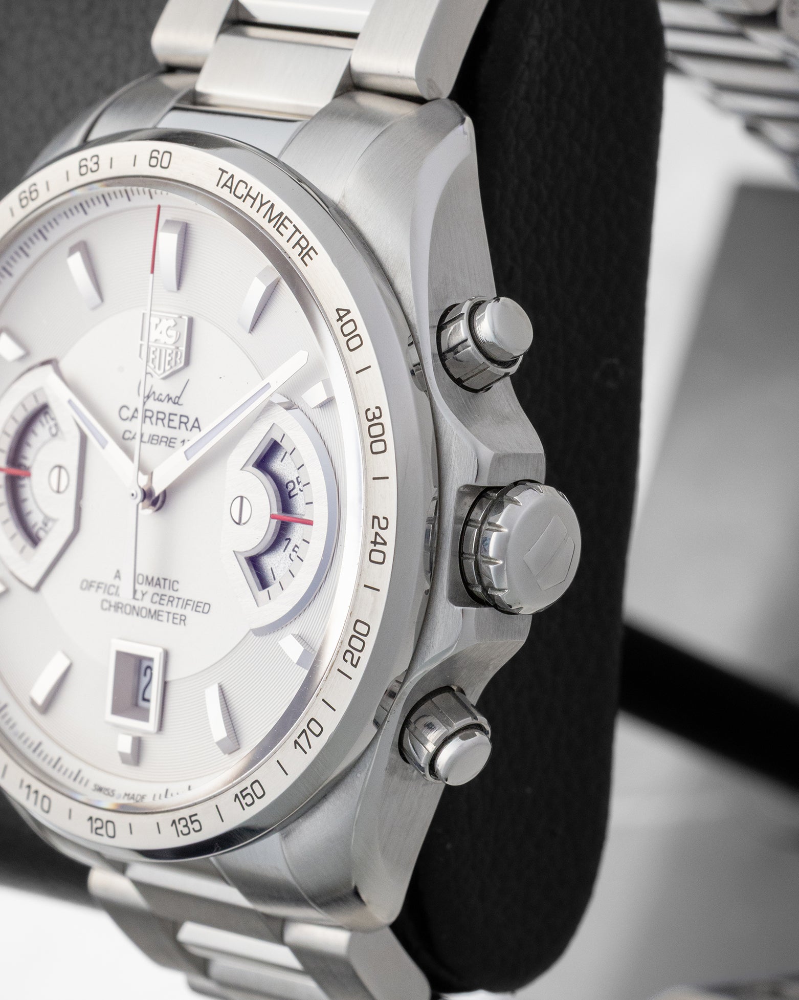 Side profile view of the stainless steel case showing the tachymeter bezel, main crown, and screw-down chronograph pushers.