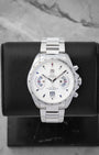 TAG Heuer Grand Carrera Calibre 17 RS Chronograph CAV511B featuring a white dial with dual rotating system disks on a black display stand