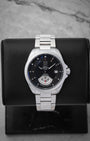 TAG Heuer Grand Carrera Calibre 6 RS automatic watch WAV511A with a black dial and running seconds rotating disk on a display stand