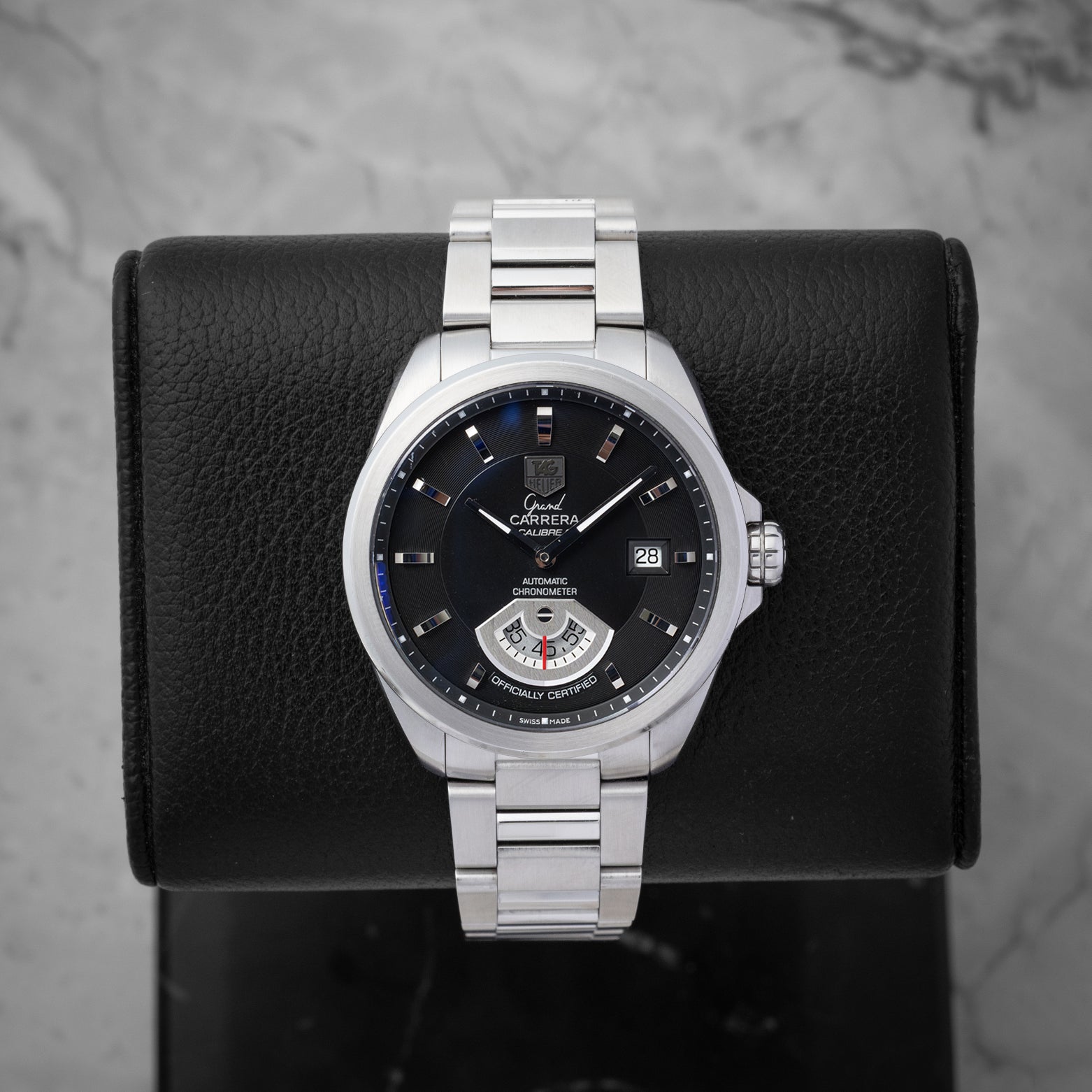 TAG Heuer Grand Carrera Calibre 6 RS automatic watch WAV511A with a black dial and running seconds rotating disk on a display stand