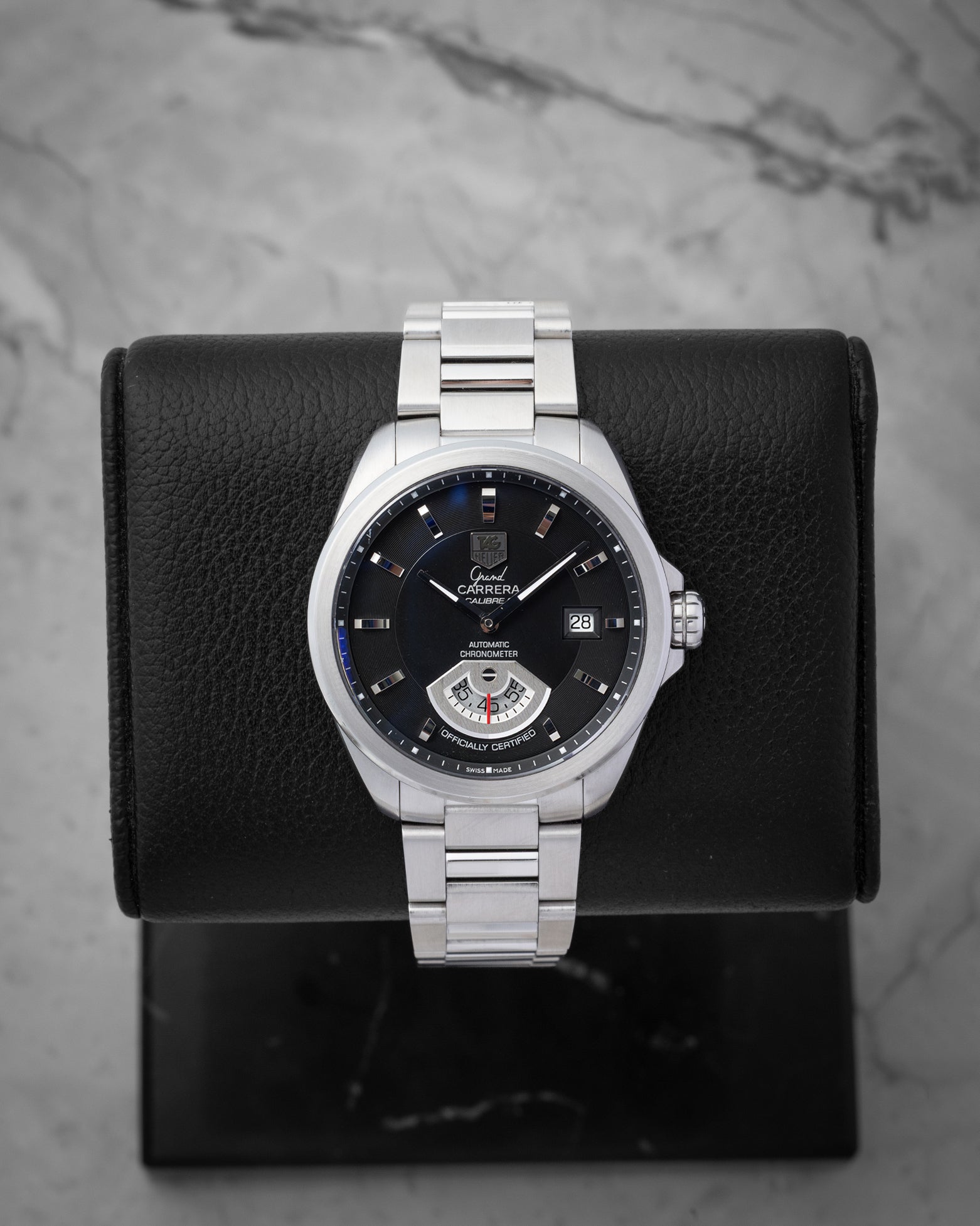 TAG Heuer Grand Carrera Calibre 6 RS automatic watch WAV511A with a black dial and running seconds rotating disk on a display stand