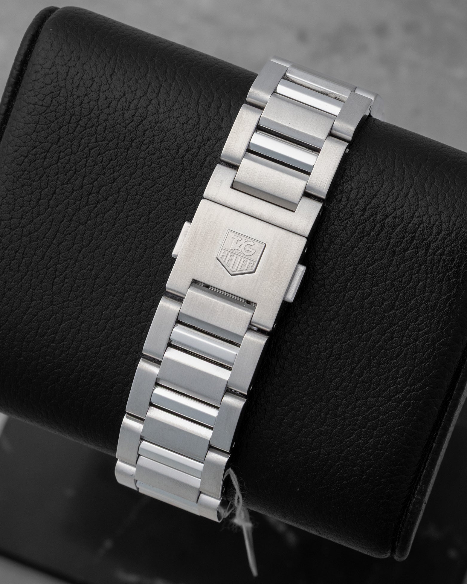 Rear studio view of the solid stainless steel link bracelet and deployment folding clasp with the engraved TAG Heuer shield logo