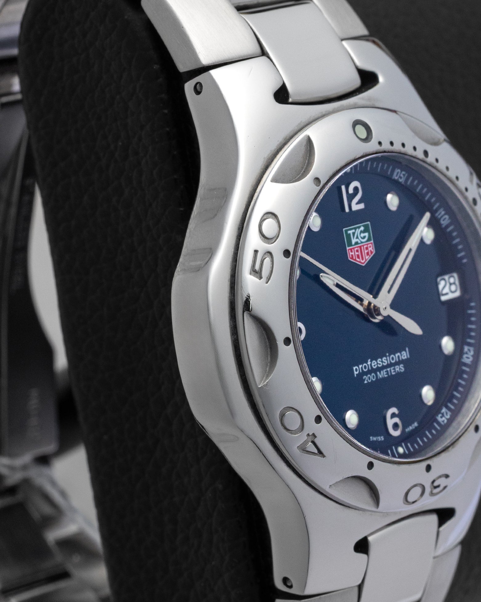Left side profile showcasing the distinct liquid metal design and brushed finish of the integrated TAG Heuer Kirium case