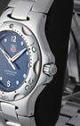 Right side profile view highlighting the unique integrated screw-down crown and unidirectional rotating steel bezel on a TAG Heuer Kirium