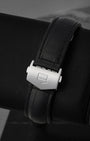 Close-up shot of the satin-finished stainless steel folding single-deployant security buckle detailed with a crisp debossed TAG Heuer shield logo outline