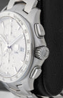 Side profile view of the stainless steel case showing the tachymeter bezel, crown guards, and sleek oval chronograph pushers