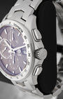 right profile view of the watch head highlighting the oversized fluted screw-down winding crown flanked by two streamlined oblong mechanical timing pushers