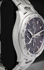 Left-side macro profile view showcasing the premium satin-brushed case wall and the clean, curved integration into the signature fluid double-S link bracelet