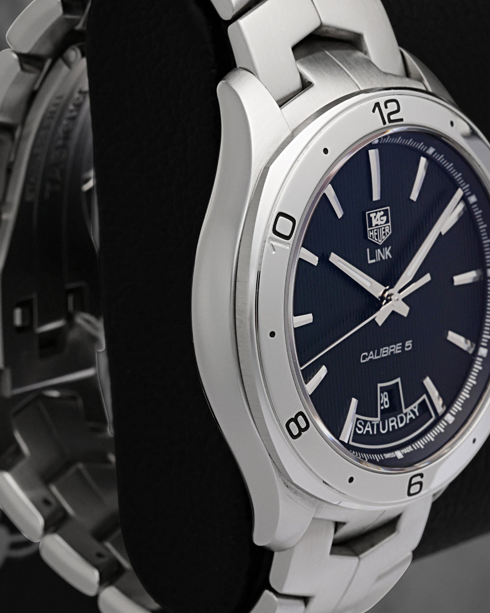 Left-side studio profile view showcasing the fine satin graining across the case wall and the seamless flow into the iconic integrated bracelet lugs
