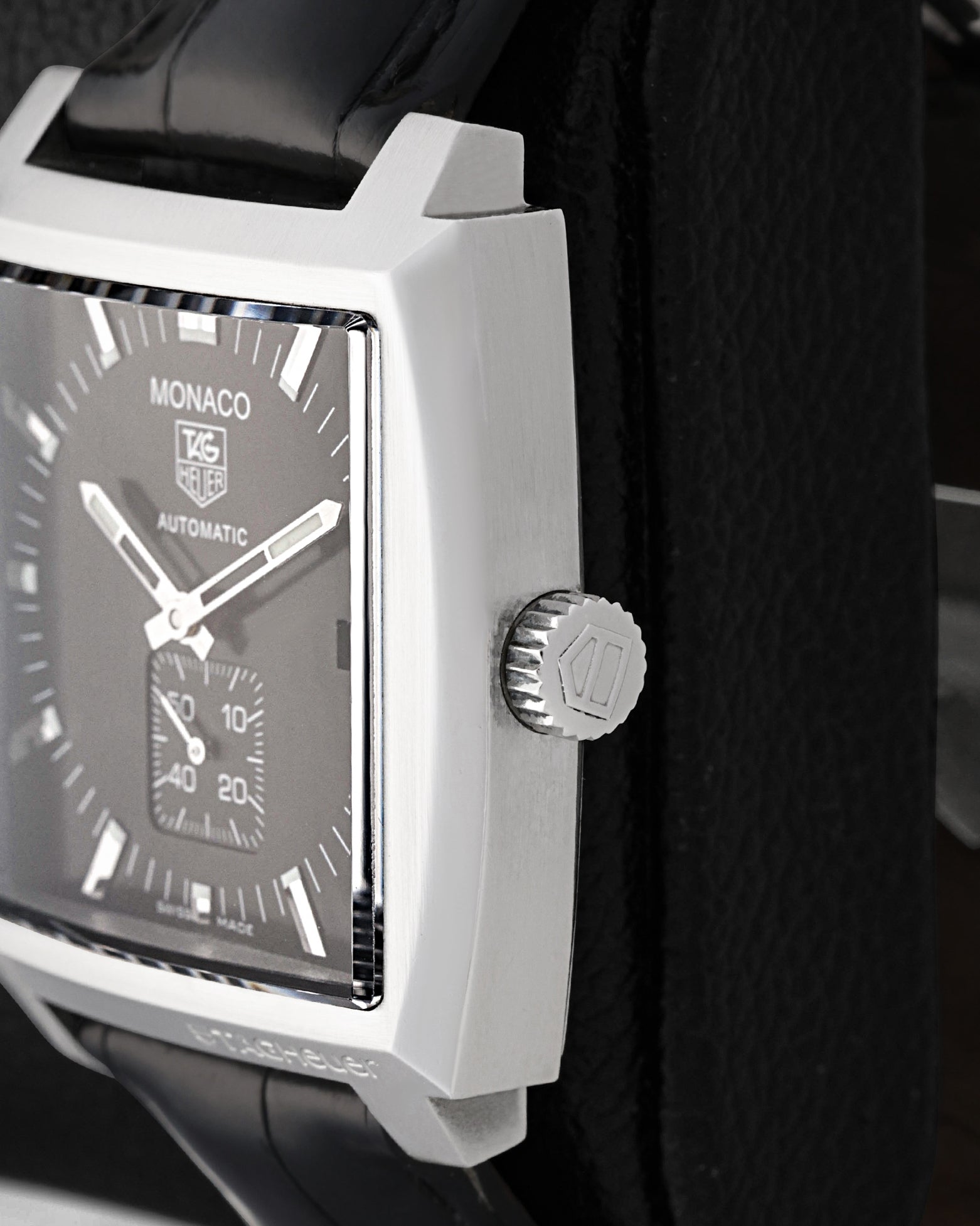 Close-up of the winding crown and polished bevels on a TAG Heuer Monaco Calibre 6