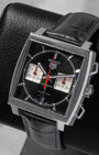 Angled front view of TAG Heuer Monaco CBL2113.FC6177 with black sunray dial, silver chronograph sub-dials, and red accents