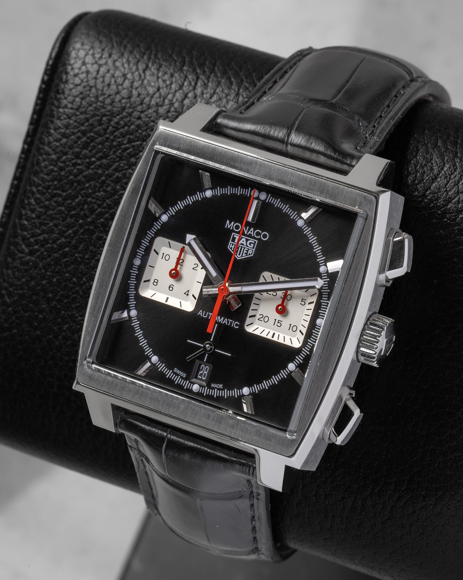 Angled front view of TAG Heuer Monaco CBL2113.FC6177 with black sunray dial, silver chronograph sub-dials, and red accents