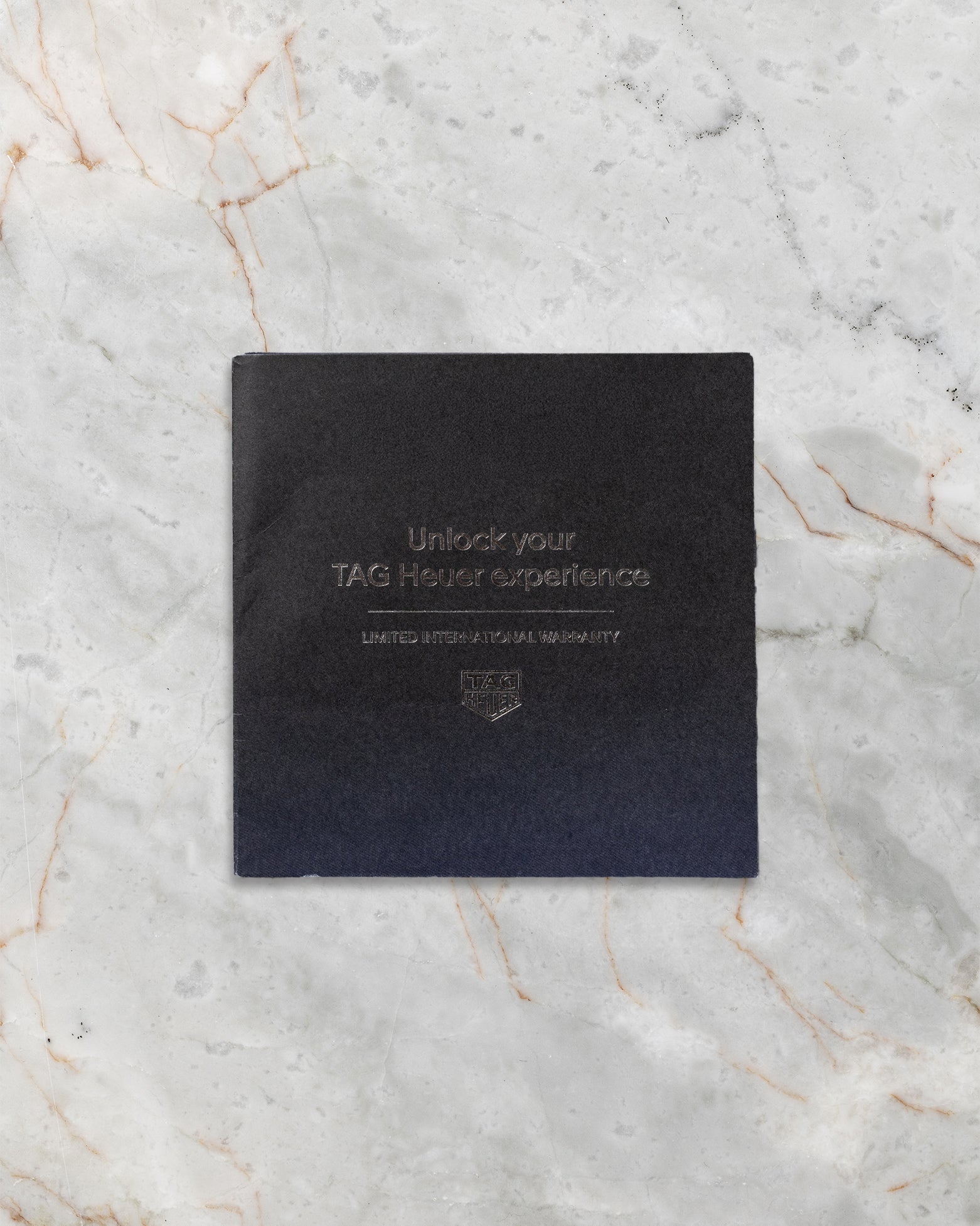 Official TAG Heuer black digital warranty card and documentation included with Monaco Chronograph CBL2113.FC6177 at Noah's Fine Watches & Jewelry