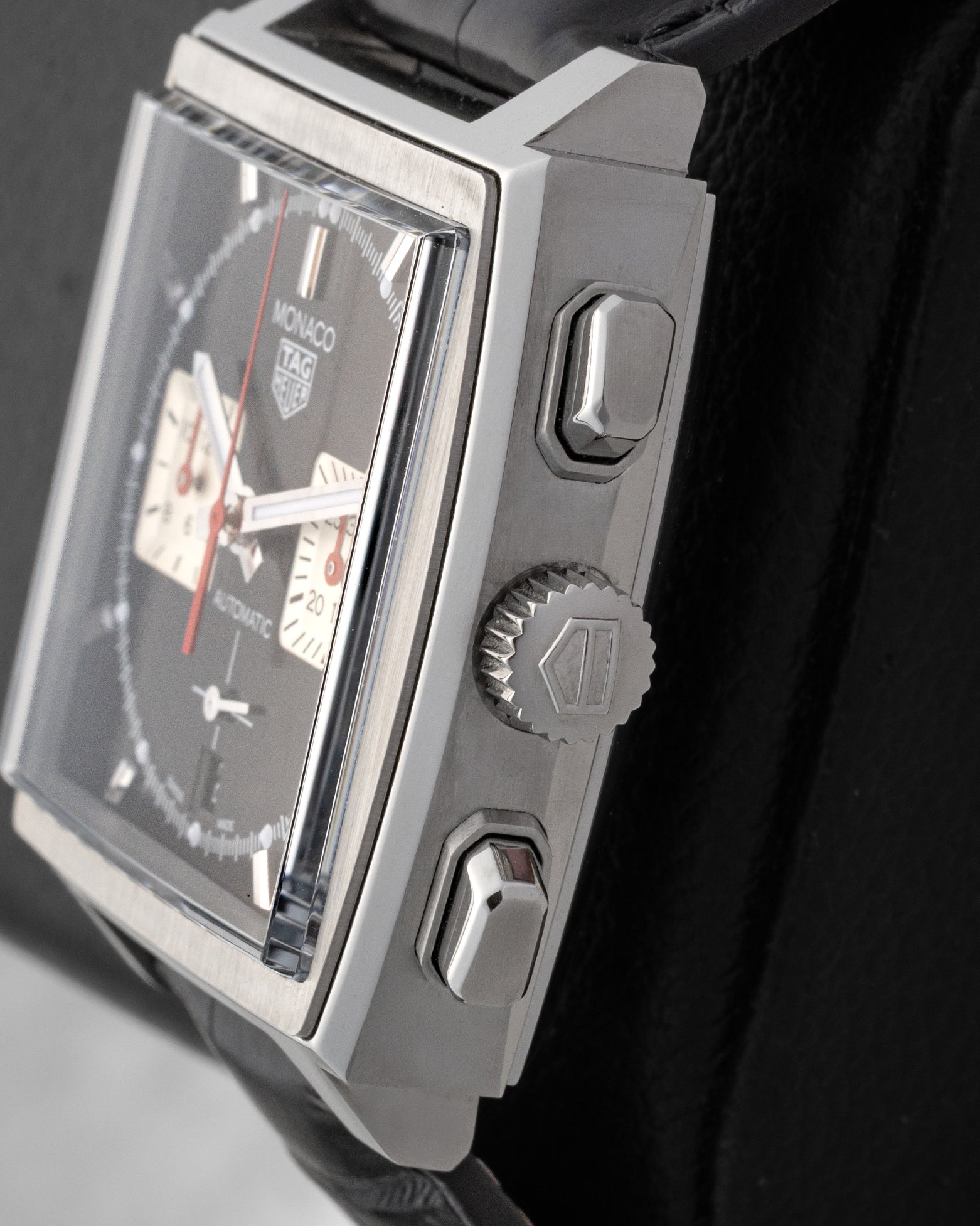 Side profile view showing the stainless steel square case, winding crown, and angled chronograph pushers on TAG Heuer Monaco CBL2113.FC6177