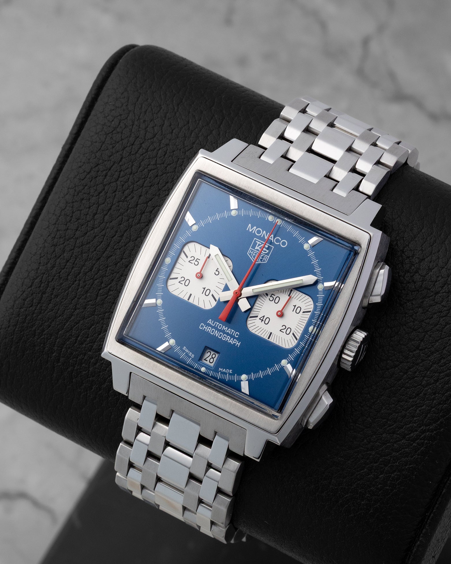 Angled front view of a preowned TAG Heuer Monaco CW2113.BA0780 featuring a classic blue dial, white square subdials, and red hands