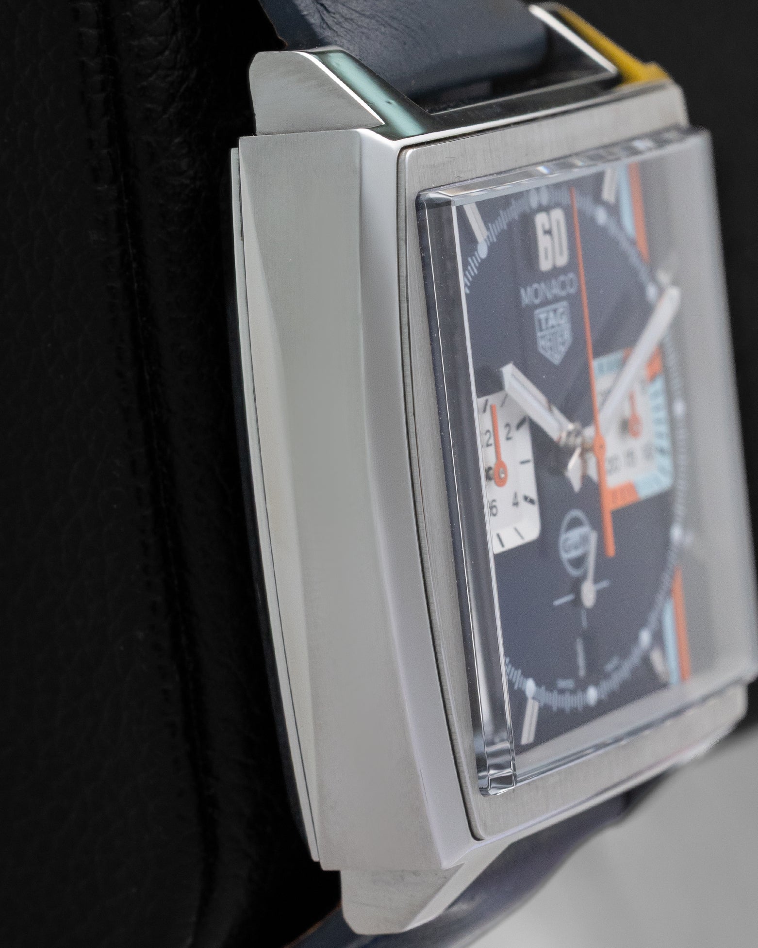 Left side profile view highlighting the fine-brushed and polished square stainless steel case design of the TAG Heuer Monaco Gulf Special Edition.